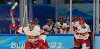 Team China goalkeeper Jeremy Smith (45) leads his team onto the ice prior to their game against Team USA on Thursday.