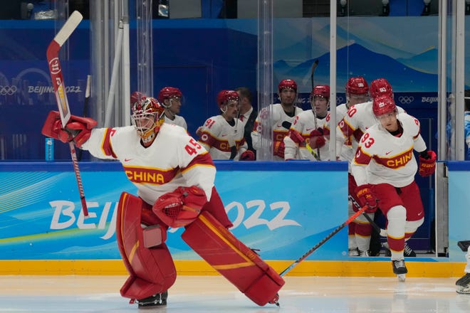 Team China goalkeeper Jeremy Smith (45) leads his team onto the ice prior to their game against Team USA on Thursday.