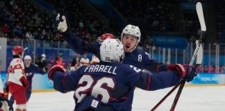 Team USA forward Noah Cates (27) celebrates with Sean Farrell (26) after scoring a goal against Team China during the second period during the Beijing 2022 Olympic Winter Games at National Indoor Stadium.