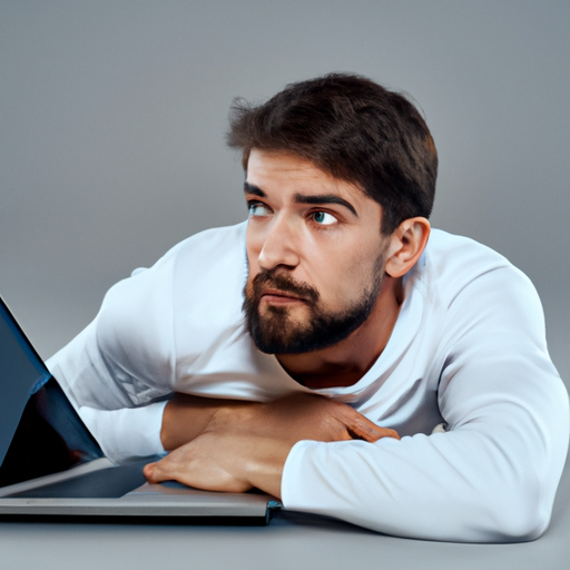 man and a laptop in front of him