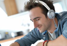 Building a Better Future: The Benefits of Pursuing an Online Social Work Degree man wearing headphone and studying in front of laptop